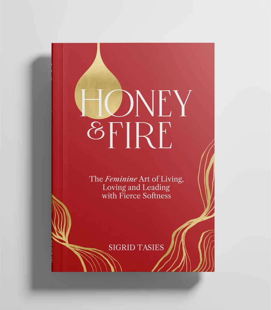 Honey & Fire by Sigrid Tasies - red hardcover with gold foil detailing, photographed on a studio backdrop