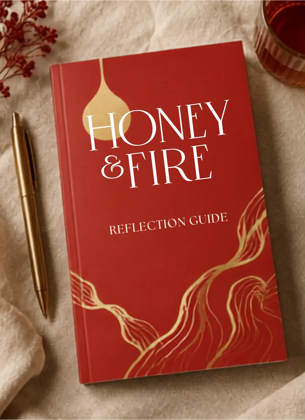 The Honey & Fire Reflection Guide beside a gold pen on linen